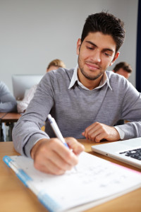 Student taking notes in university class